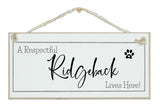 A.....dog breed, lives here signs